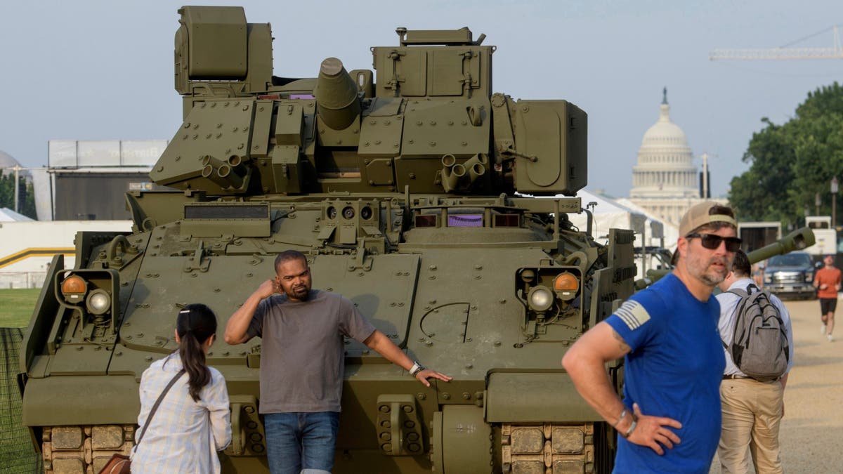People are going and taking pictures with a tank, parked at the National Commercial Center, during preparations for a coming military parade celebrating the 250th anniversary of the army and coincided with the birthday of President Donald Trump, 79, Thursday, June 12, 2025, in Washington.