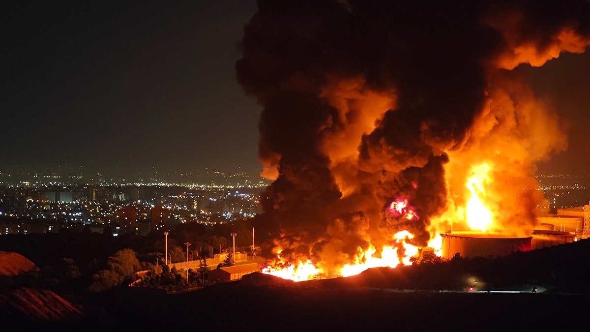 Fire and smoke rises from the Iranian oil warehouse