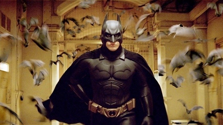 Christian Bell, as Batman, is surrounded by bats in Batman begins