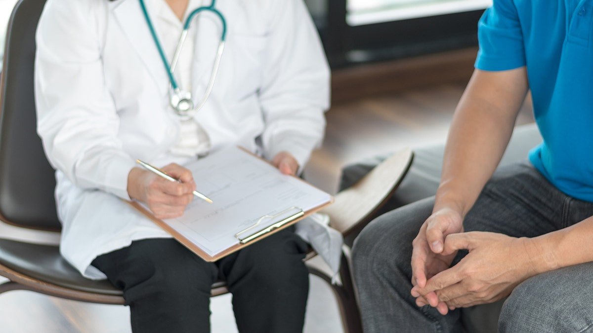 A doctor sitting with the patient