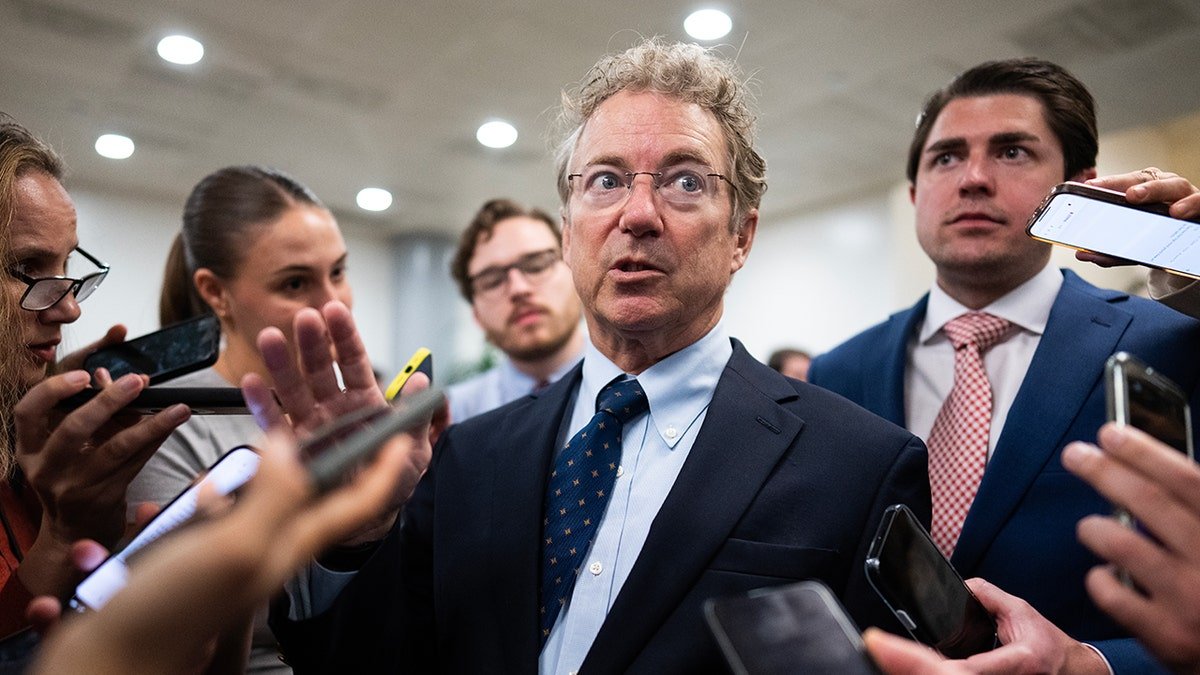 Rand Paul surrounded by journalists in May 2025