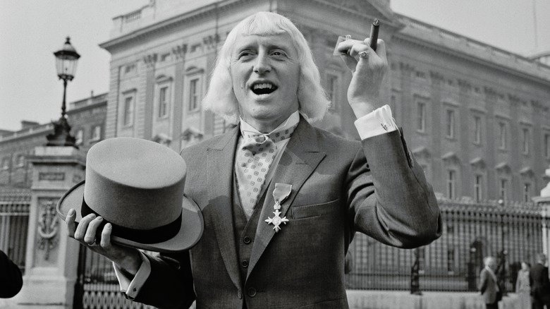 Jimmy Savil is outside Buckingham Palace