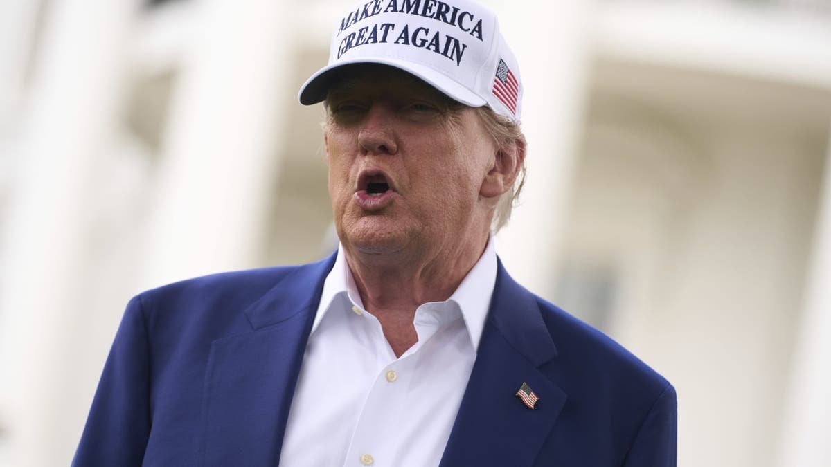 President Donald Trump speaks with correspondents before installing the flag column in the southern grass of the White House, on Wednesday, June 18, 2025, in Washington. (AP Photo/EVAN VUCCI)