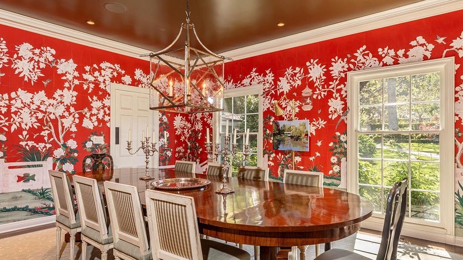 The dining room is characterized by bright red background with white floral designs.