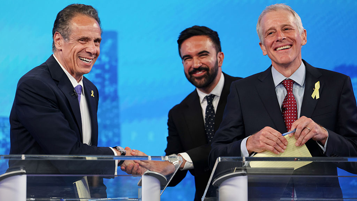 Como laughs, shaking hands with Mamdani