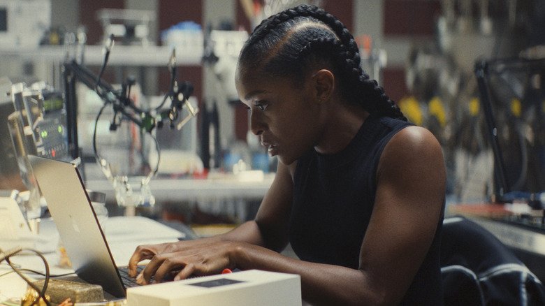 Rirry Williams in a laboratory, working on her laptop