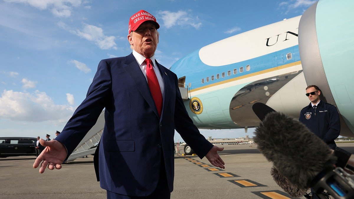 Trump is on the airport runway, one air force behind him
