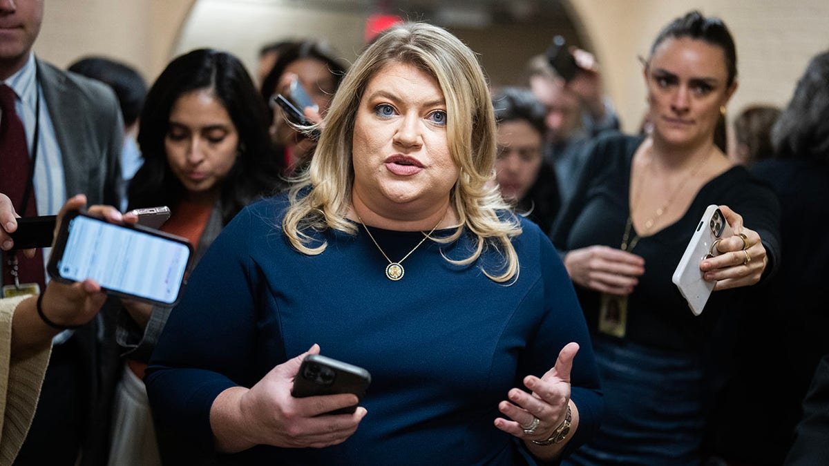 Representative Cammack amid the press in the hallway