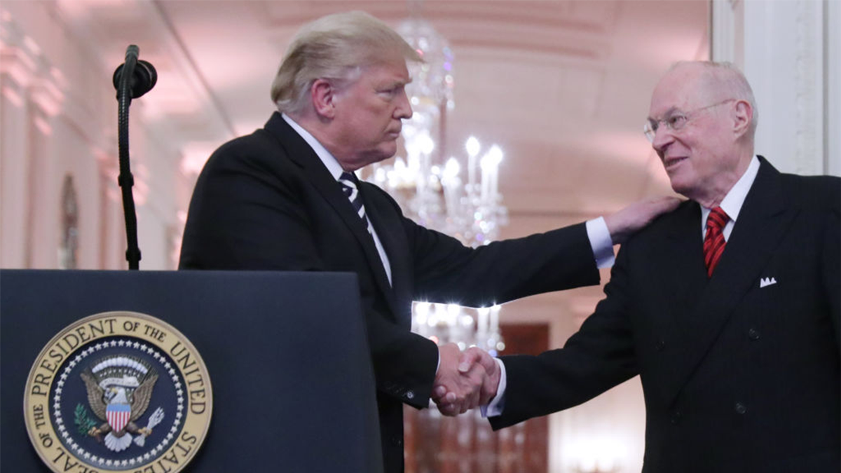 President Donald Trump is walking with retired judge Anthony Kennedy