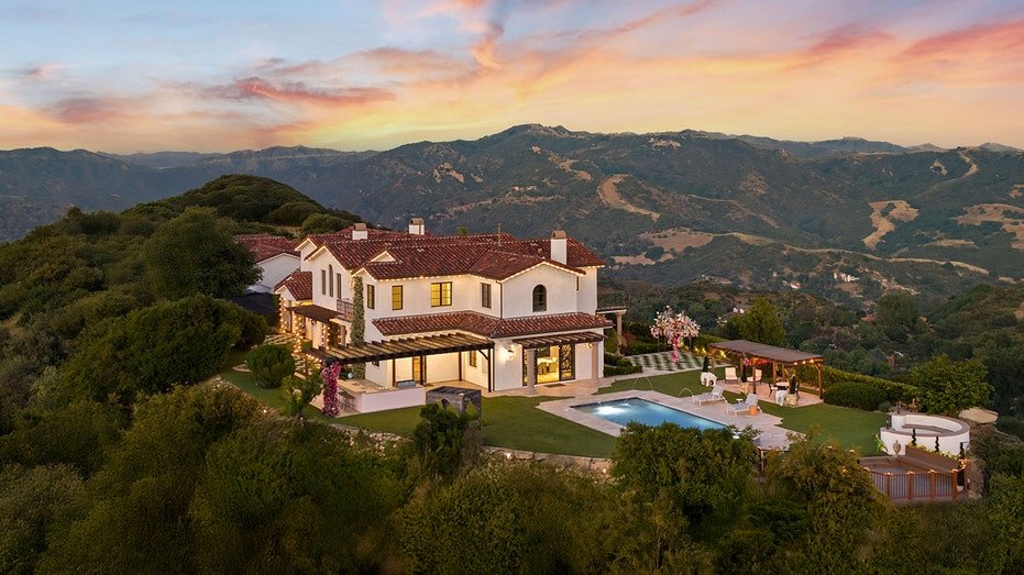 A house on hill with mountain views.