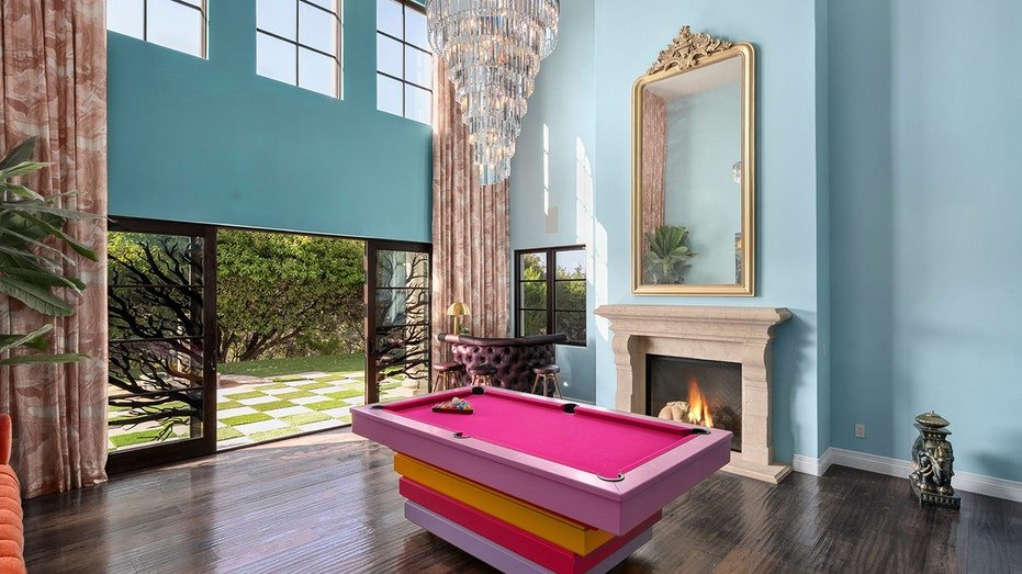 The wonderful room features high ceilings and a fireplace located on firewood.