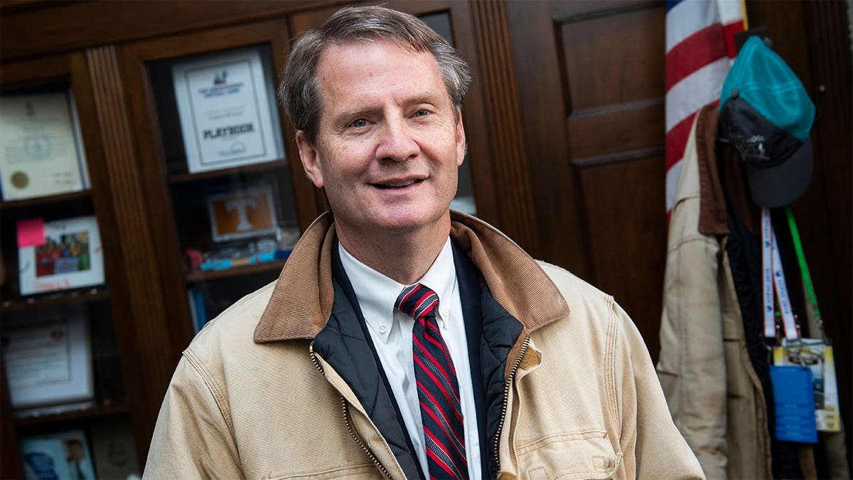 Representative Tim Porsket wears a Tan jacket in a room
