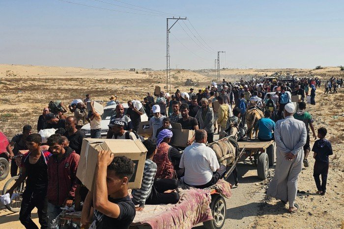 The displaced Palestinians are running along a road to receive humanitarian aid packages from the United States -backed institution in a ravine in the southern Gaza Strip on June 5