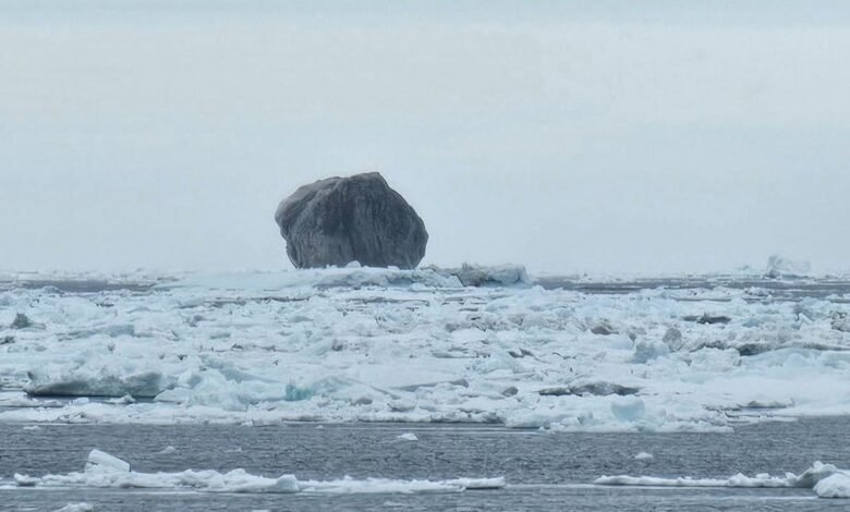 Sailor Snaps Photo of Black Iceberg With Dark Veins.jpg