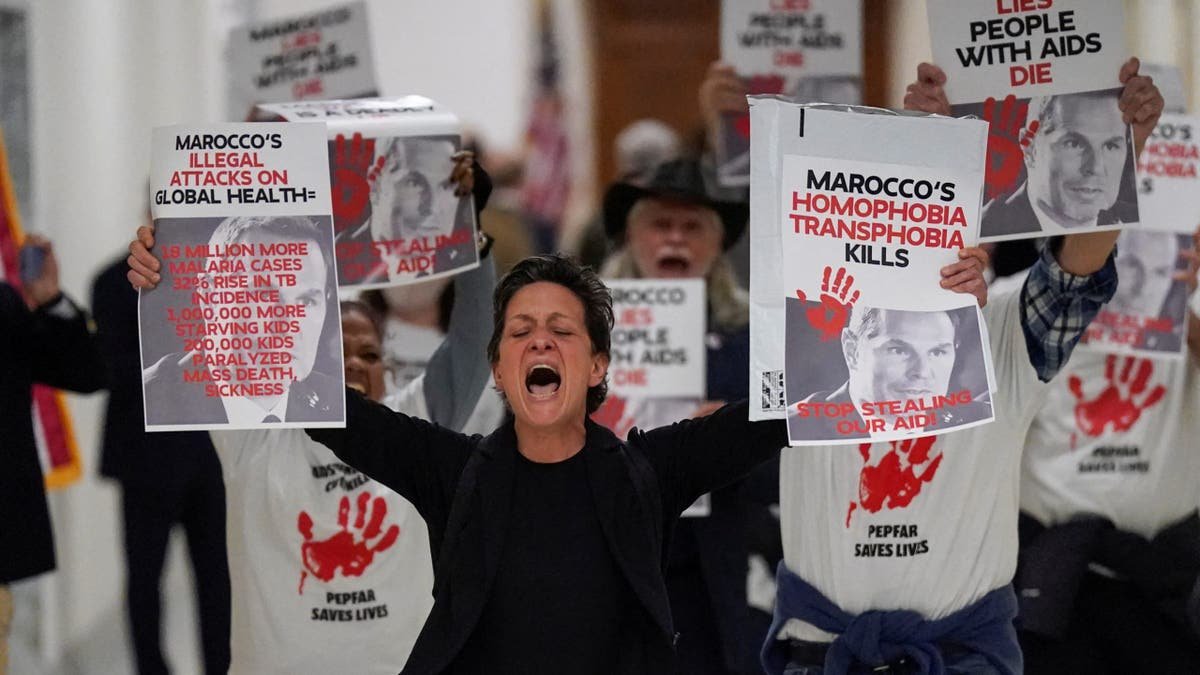 The demonstrators with signs, wearing black clothes