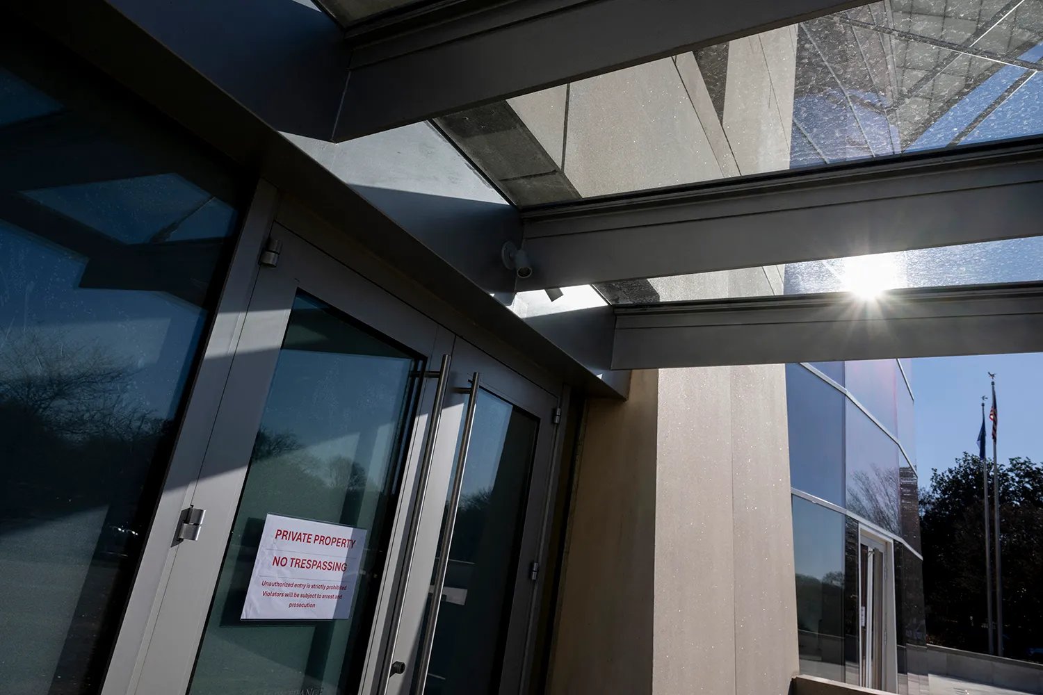 A sign that reads "Private property no trespassing" is posted on one of the doors of the US Institute of Peace.