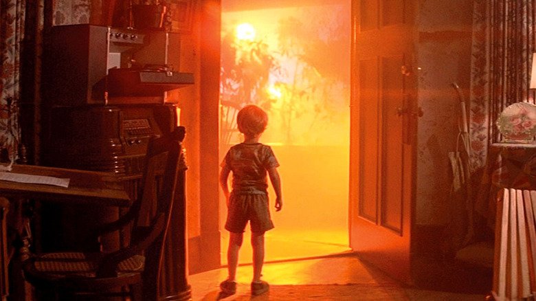 A child looks at a spacecraft outside his front door in close -up meetings