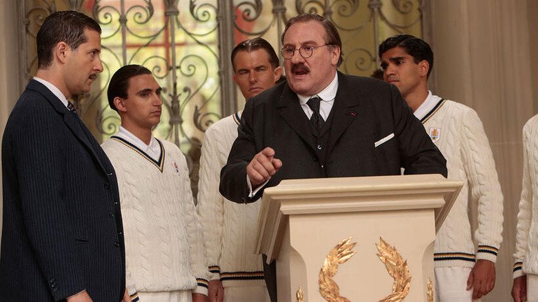 Gul Remett on a platform, football players behind him, in the United Emotions