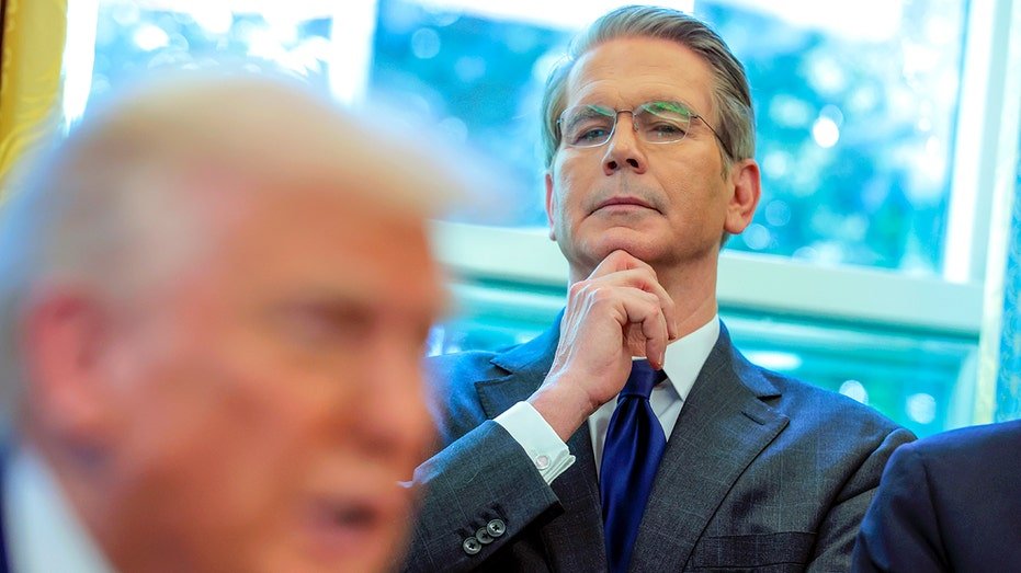 Scott Beesen stands behind Donald Trump