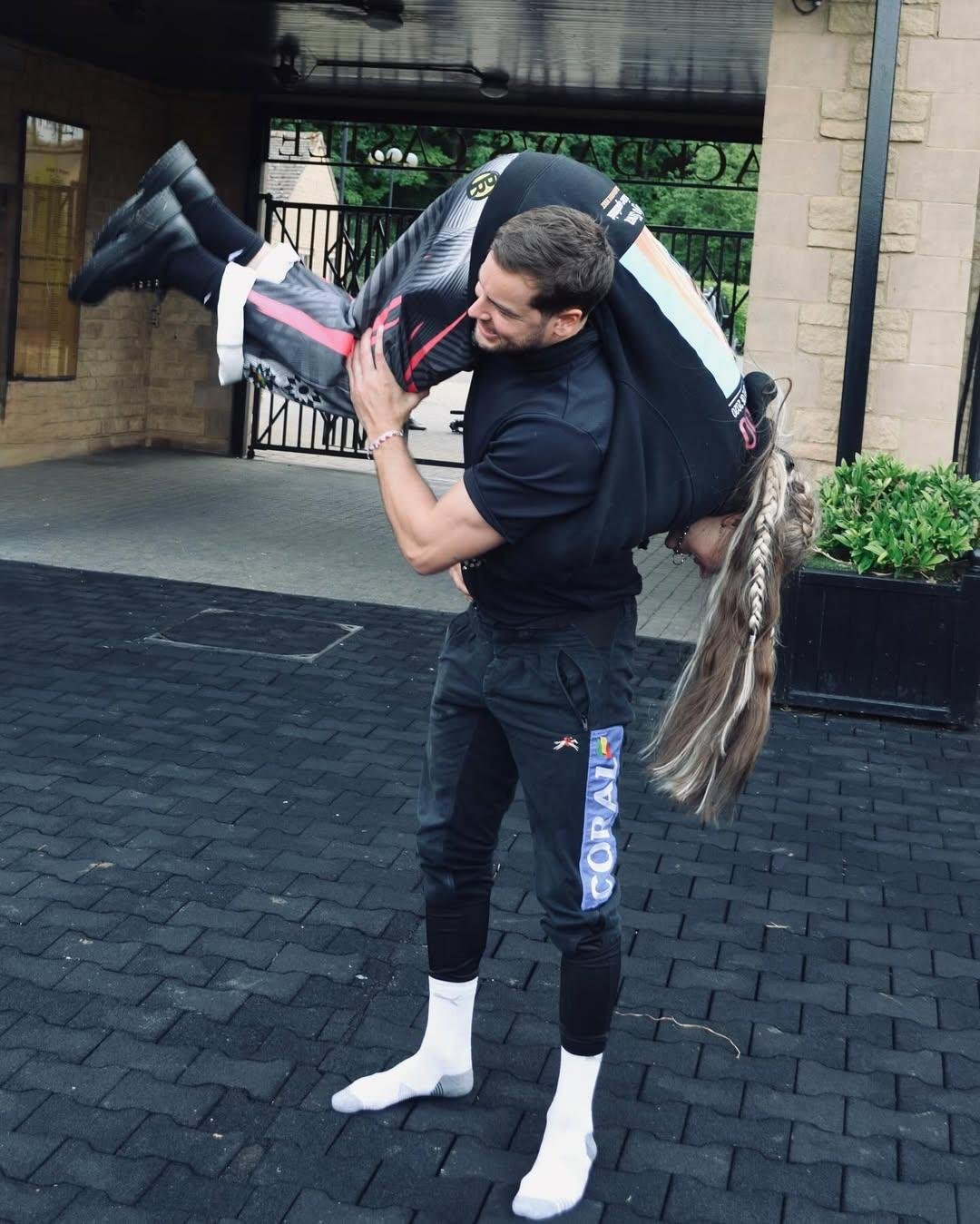 Chris Hughes holds Jojo Siwa