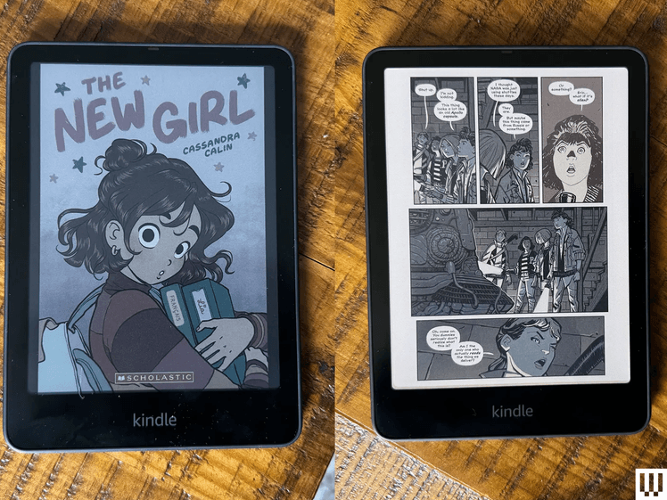 Overhead view of two black Kindle Colorsoft e-readers, with one screen showing the cover of an e-book and the other screen showing comic strips