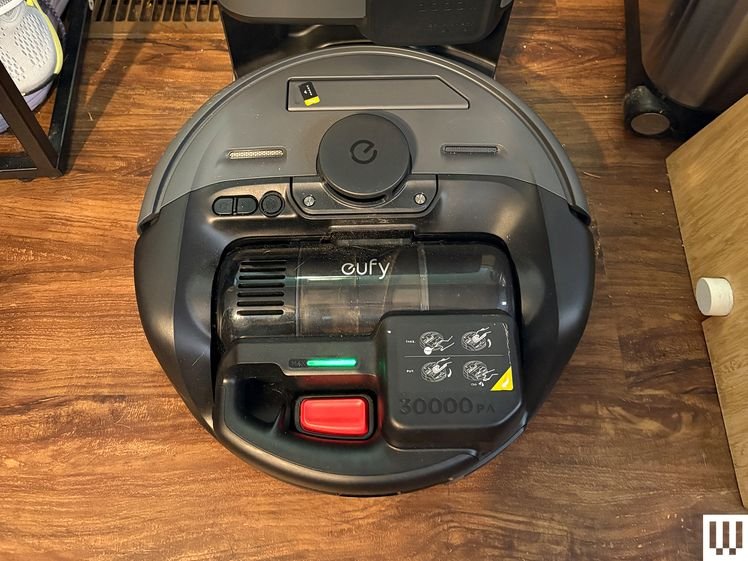 Overhead view of Eufy E20 3-In-1 Robot Vacuum at the grey rectangular docking station