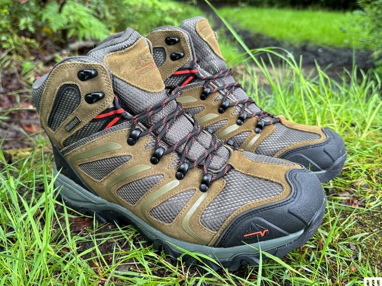 Nortiv 8 Armadillo 2, a pair of grey and green books, sitting in grass and dirt