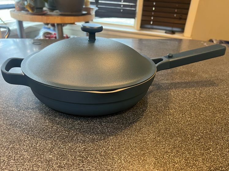 The image may contain: cooking tools, cooking pan, office, furniture, and table
