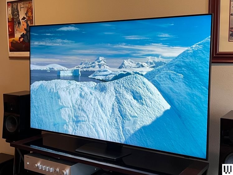 Front view of the Samsung QN90D QLED TV with the screen showing a scene of icebergs in the ocean on a sunny blue sky day
