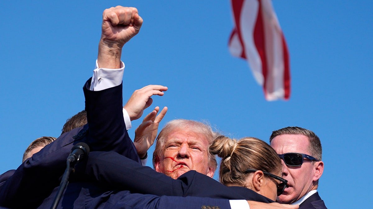 Former Republican presidential candidate Donald Trump is surrounded by American secret services agents in a campaign gathering