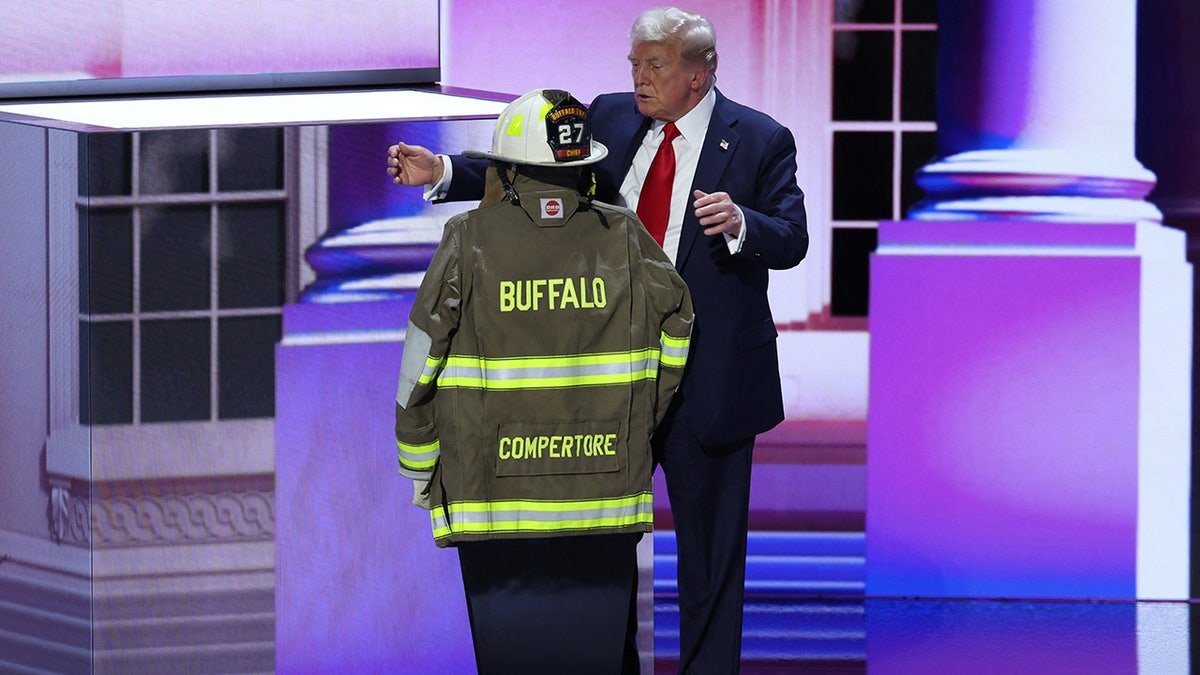 Donald Trump embraces the turnout coat and helmet the head of the fire extinguishing department in the former town
