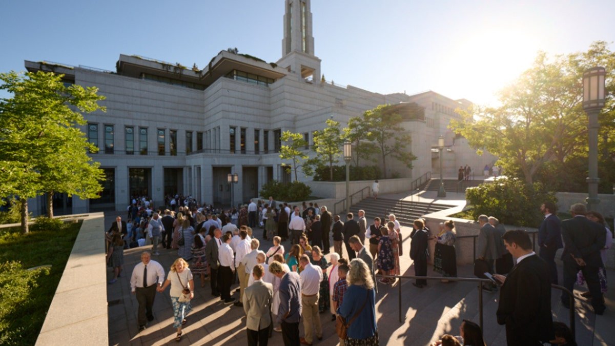 People stand outside the conference center
