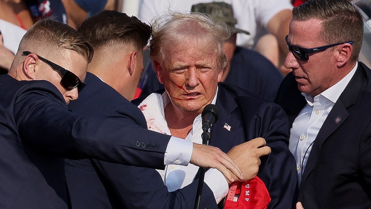 Donald Trump hints with a blood stained, as he rang multiple shots during a campaign gathering