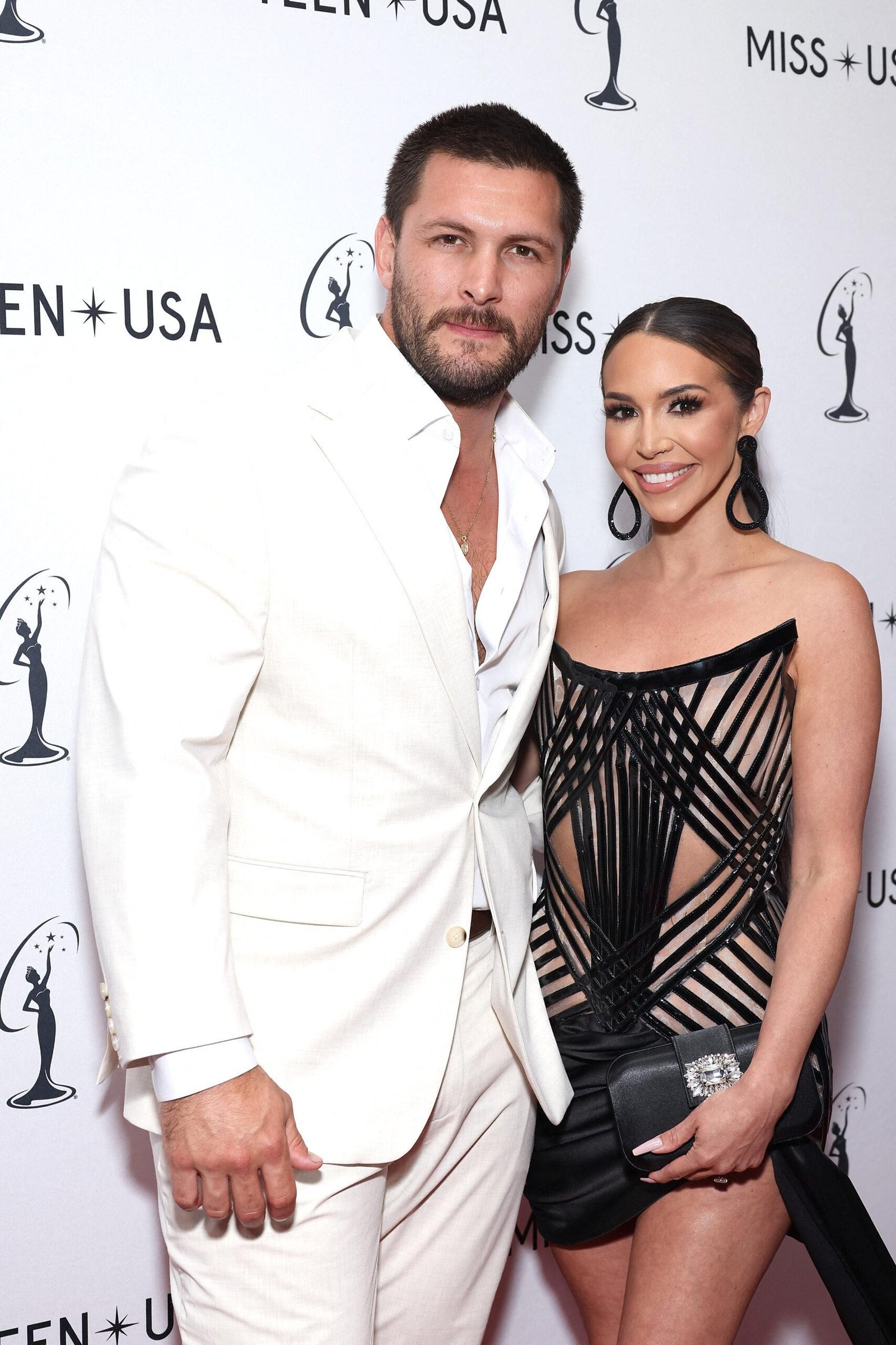 Shina Tea and Brock Davis frozen together on the red carpet.