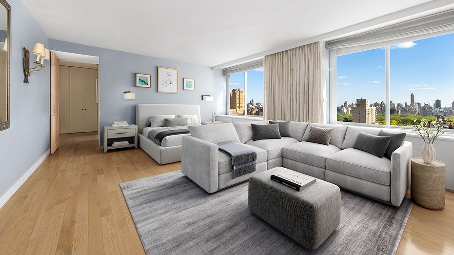 The initial bedroom has views of the city and a wide seating area.