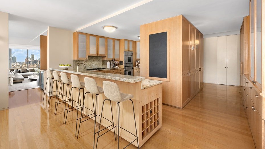 The kitchen features dining tape and wooden cabinets.