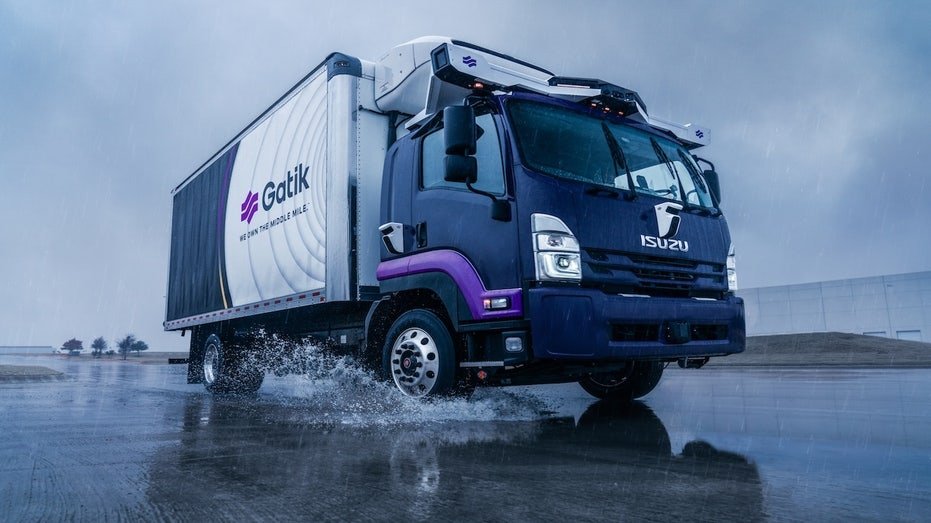 A truck driving a pool of water