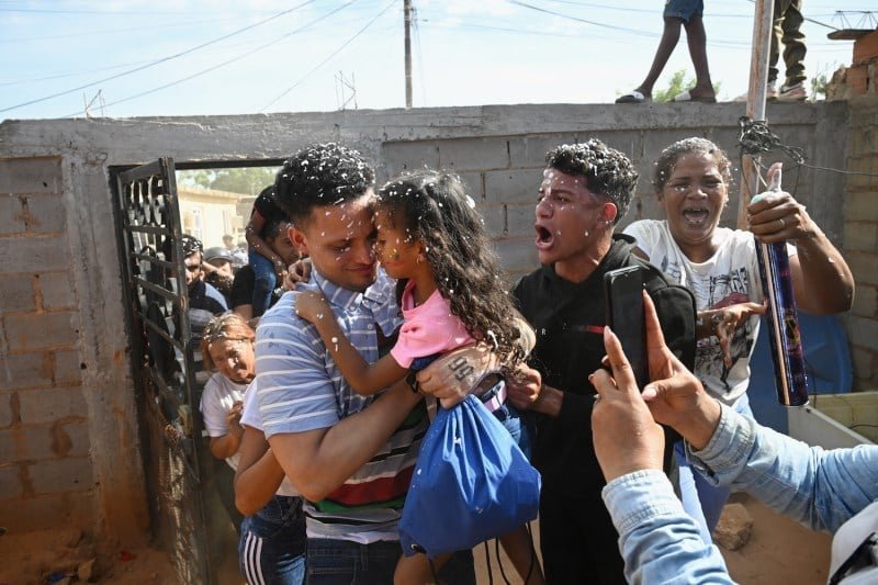 Murvin Yamarti, the Venezuelan immigrant who was returned home from a prison in El Salvador, embraces his daughter upon his arrival at his home in Maracapo, Venezuela, on July 22.
