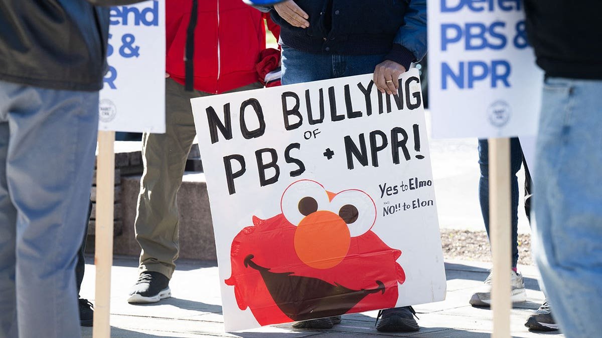 People participate in a march to invite Congress to protect the financing of public broadcasters outside the NPR headquarters in Washington, DC.
