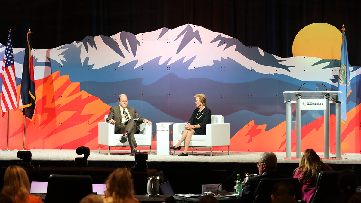 State Governor Jared Police and Amin Linda McMahon on stage