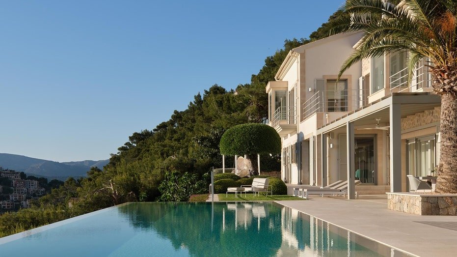 The backyard is characterized by swimming on the edge of the property.