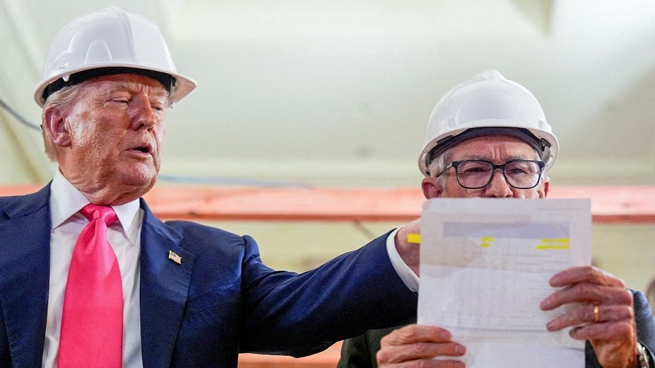 Powell Fact checks the numbers on a document after Trump submits a project costs