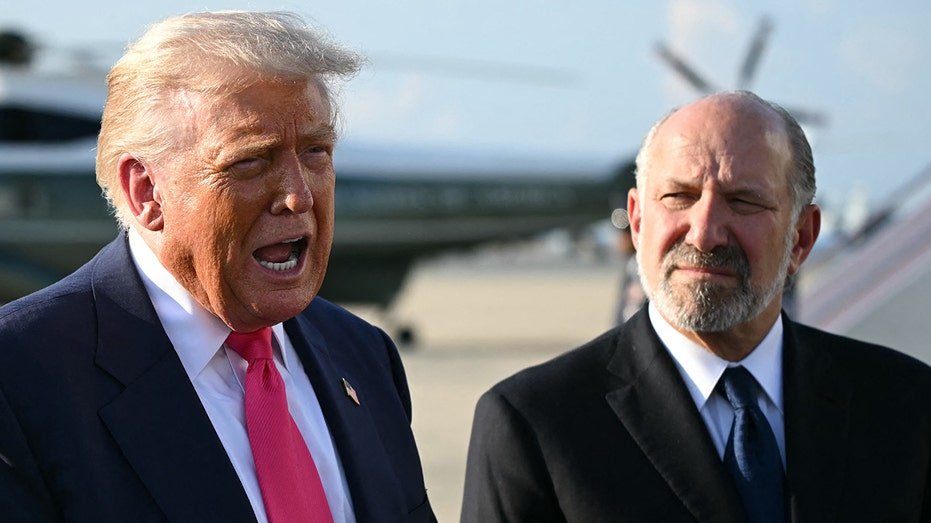 President Donald Trump and Minister of Commerce Howard Lootnick stands side by side