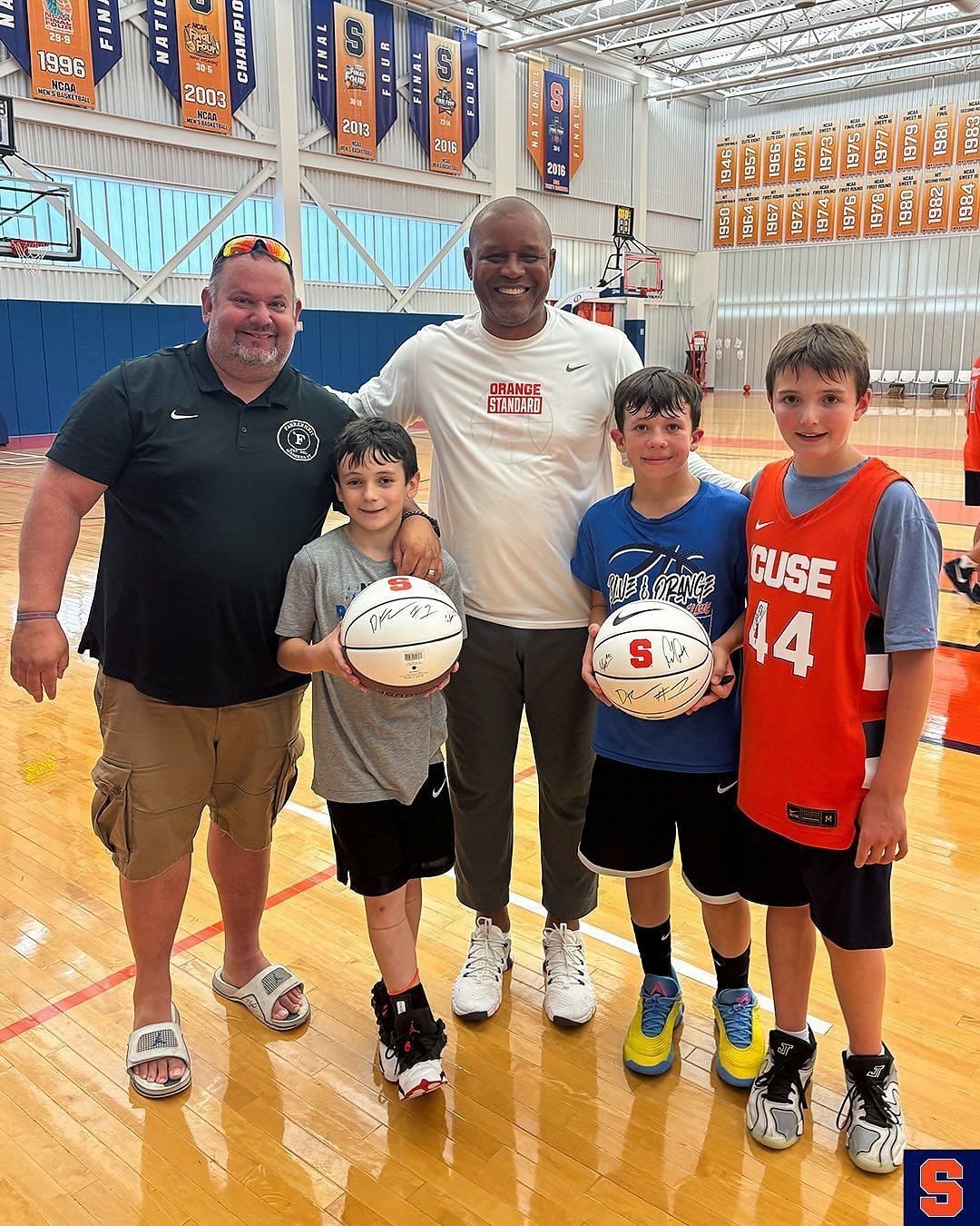 Coach Red Autry puts a picture with young Hoopers (image via Instagram Cuse_MBB)