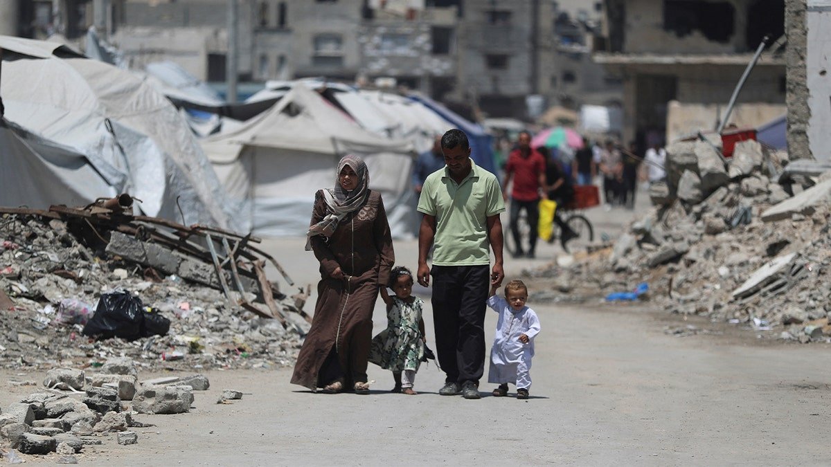 The Palestinians are walking through the rubble in Gaza