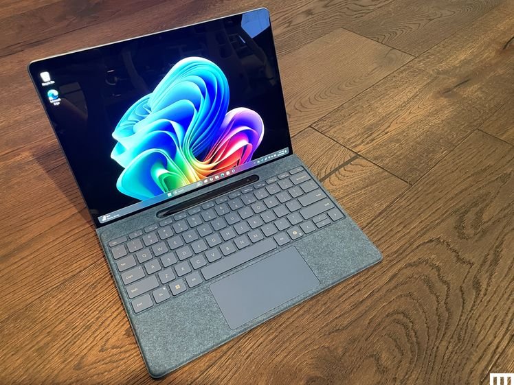 Microsoft Surface Pro Tablet connected to a separate keyboard, sitting on a wooden floor.