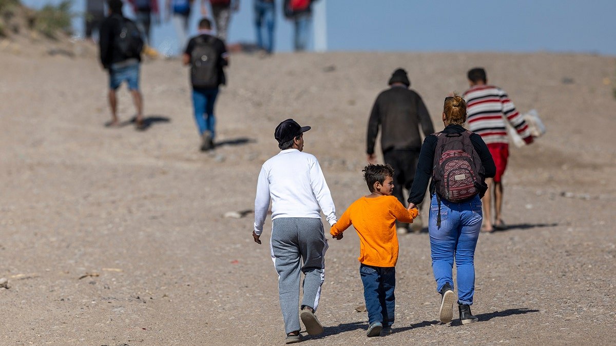 Immigrants walk in the desert