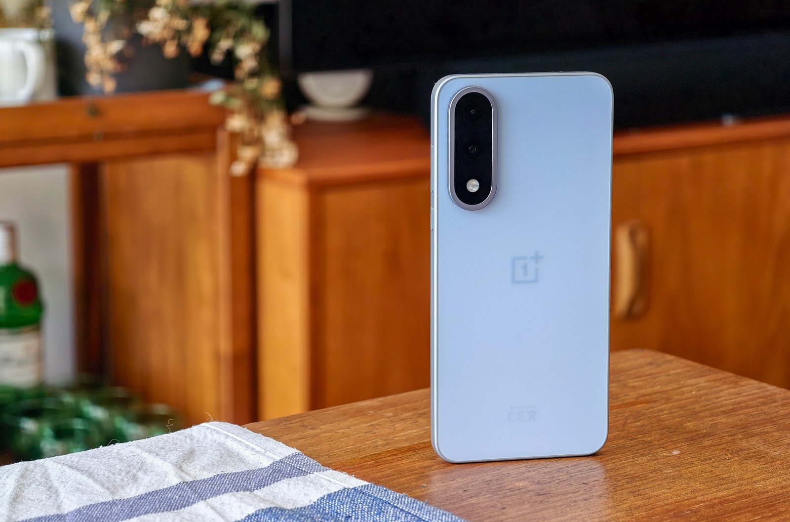 OnePlus Nord 5 image on a wooden table.