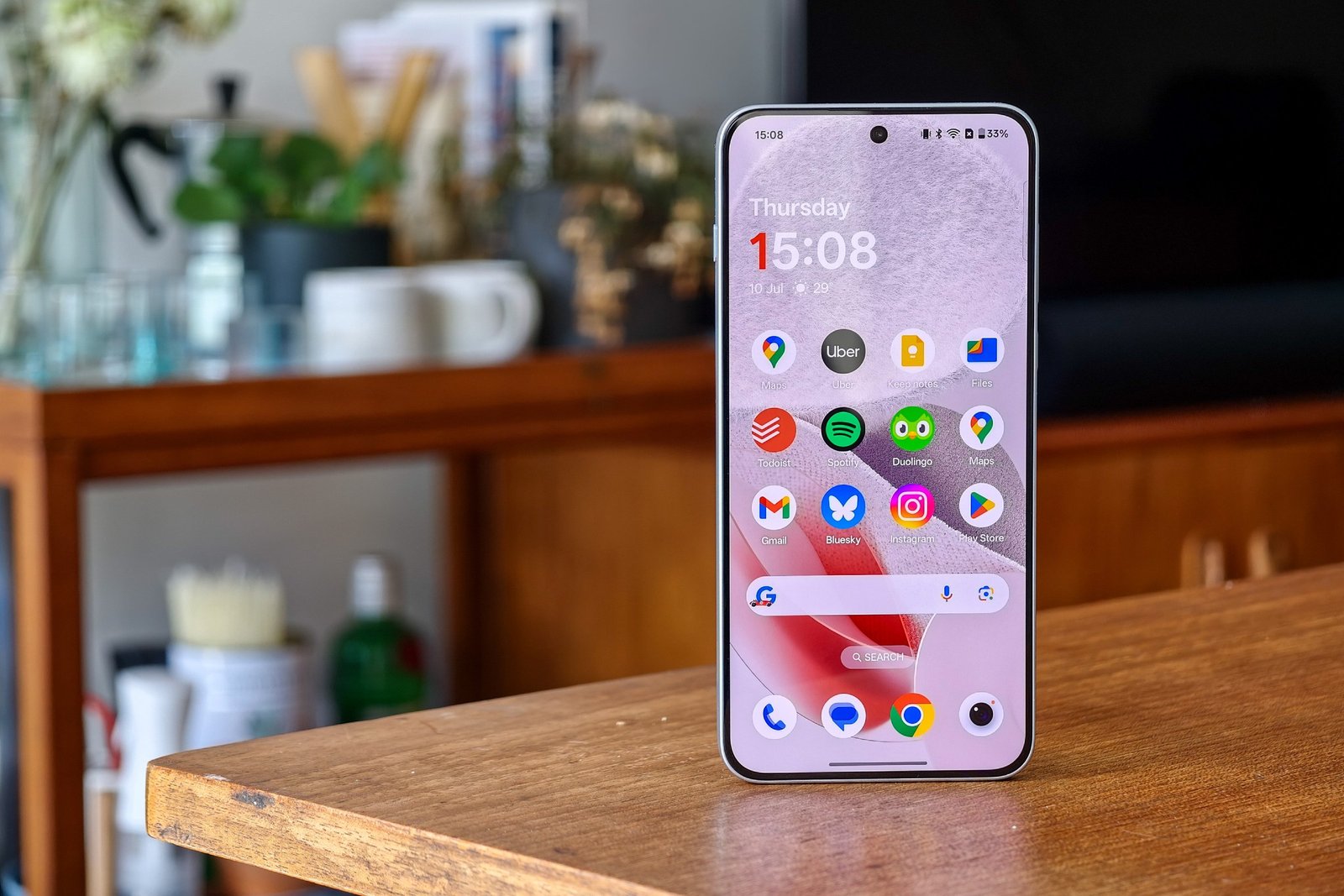 OnePlus Nord 5 image on a wooden table, with the main screen in the display