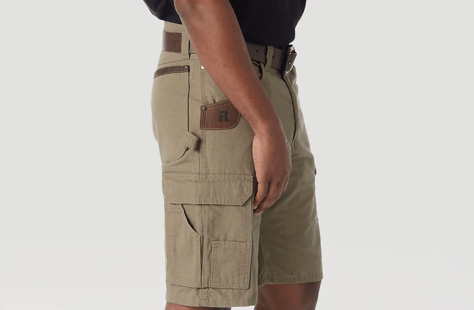 Bottom part of person wearing tan shorts